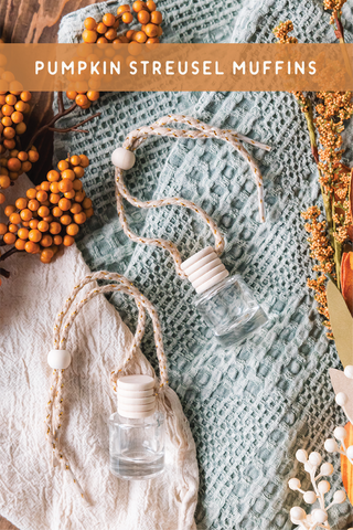 a bottle of pumpkin streusel muffins sitting on a towel next to
